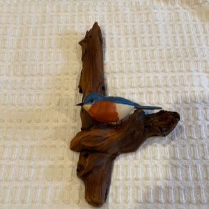 Featherwood fine Carvings and Paintings. Bluebird on a wood branch.